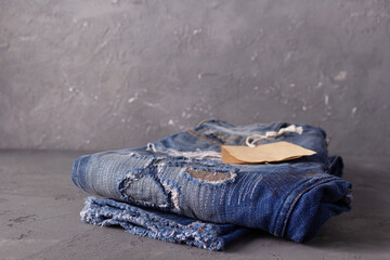 Wall Mural - Paper price tag label on jeans background texture. Blue jeans denim fabric