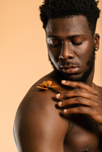 African Man Touching Butterfly On Shoulder Studio Portrait
