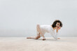 © Tania Cervian/Stocksy - Female dancer crawling and leaning on hand