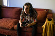 © Ana Luz Crespi/Stocksy - Trans girl very focused on console video game