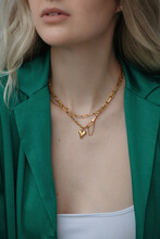 Anonymous Woman Wearing Gold Chain With Heart