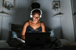 © Ezequiel Giménez/Stocksy - African American teenager using laptop on bed