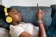 © Ezequiel Giménez/Stocksy - African American teenager watching video on smartphone
