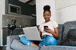 © Ezequiel Giménez/Stocksy - Low angle of a seated young woman with a laptop computer