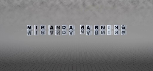 Wall Mural - miranda warning word or concept represented by black and white letter cubes on a grey horizon background stretching to infinity