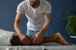 © Milles Studio/Stocksy - Crop masseur pinching calf to ease tension
