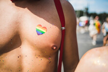 Close Up Of A Rainbow Heart Sticker On A Fit Male's Chest