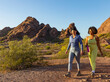 © Raymond Forbes LLC/Stocksy - Two young friends hike together in Arizona Desert landscape