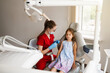 Child girl afraid dentist. Childrens dentist consults frightened kid in dentistry. Treatment of teeth and toothache in children.