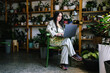 © Oleksii Syrotkin/Stocksy - Female manager preparing online requests from floral shop