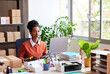 © ALTO IMAGES/Stocksy - Woman working on laptop in office of delivery service