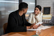 © Bisual Studio/Stocksy - Businesswoman listening to black colleague in office