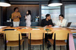 © Bisual Studio/Stocksy - Diverse employees working and taking break in office