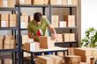 © ALTO IMAGES/Stocksy - Logistic manager preparing carton box