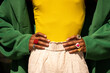© Alba Vitta/Stocksy - Cropped black man wearing rings and colorful apparel