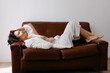 © Tania Cervian/Stocksy - Fashionable woman resting on couch