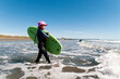 © Thomas Pickard/Stocksy - Confident young female surfer. New Zealand.