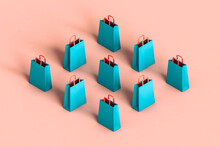Rhombus Of Blue Shopping Bags In Different Positions On Pink Bac