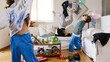© Nasos Zovoilis/Stocksy - Kids playing with balloons in the living room