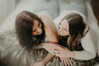 © Chelsea Victoria/Stocksy - Beautiful Lesbian couple cuddling