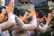 © Jovo Jovanovic/Stocksy - Balinese family praying together wearing traditional clothes