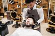 © Hernandez & Sorokina/Stocksy - Massage Procedure For Client At Barbershop
