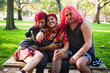 © Ana Luz Crespi/Stocksy - Group of transgender friends sitting in a park