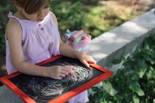Little Girl Drawing In The Backyard