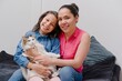 © Wil.Amaya - mother and daughter playing with their pet cat