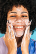 © Manu Prats/Stocksy - Hispanic woman cleansing face with handmade soap