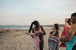 © Pedro Merino/Stocksy - Group of multi-ethnic friends enjoying after a swim in the sea