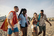 © Pedro Merino/Stocksy - Multiracial group of friends on the beach