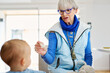 © Guille Faingold/Stocksy - Grandmother feeding grandson with spoon.