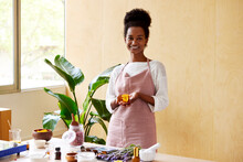 Optimistic Black Woman Showing Jar Of Organic Cream