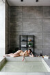 © Sergey Narevskih/Stocksy - Relaxed woman lying on pool border in spa center