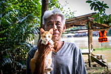 A Portrait Of A Fisherman With His Favorite Kitten