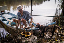 A Fisherman Lets His Cats Board His Longtail Fishing Boat