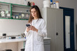 © Hernandez & Sorokina/Stocksy - Woman Using Phone In Lab