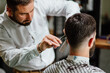 © Boris Jovanovic/Stocksy - Hairdresser using clippers to cut hair