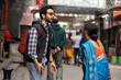 © Dream Lover/Stocksy - Indian Young Couple Standing In A Busy Road And Making Conversation