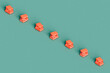 © Giada Canu/Stocksy - a row of a stack of pink books