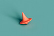 © Giada Canu/Stocksy - a pink spinning top on a blue background