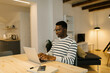 © STUDIO TAURUS/Stocksy - Black man typing on the computer indoors