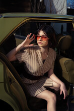 Stylish Woman Sitting In The Old Car