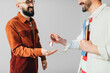 © Studio Firma/Stocksy - Realtor Giving Keys to Client