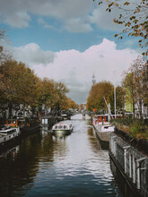 Canal In Amsterdam With Floating Boat