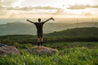 © Leonardo Borges/Stocksy - Man on a rock in the middle of the mountain.