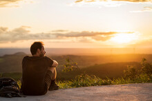 Man Sitting Enjoying A Sunset