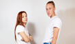 © María Soledad Kubat/Stocksy - Fashion girl and guy in outlet clothes posing on a white background