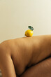 © Sophia Hsin/Stocksy - Bare back with lemon balanced on top